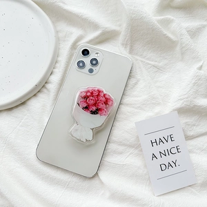 Pink rose flower phone grip and stand on silver smartphone with aesthetic white background