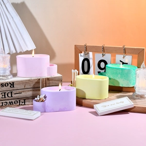 Detail of four colorful oval scented candles with built-in match storage slots and matches