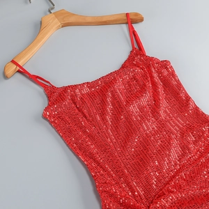 Close-up of red sequin dress on wooden hanger showing intricate texture and high shine