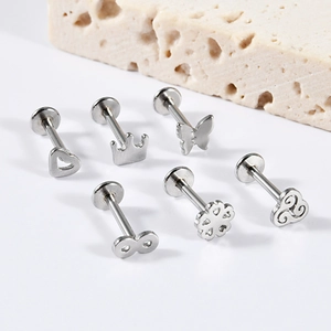 Detailed set of silver stainless steel flat back studs with crown and butterfly designs