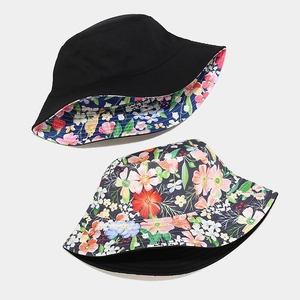 Reversible floral bucket hat for women with black side and colorful flower pattern