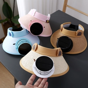 Flat lay of colorful solar powered fan sun visors for kids in multiple pastel colors