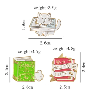 Detail view of cartoon cat and bunny enamel pins with weight and size specifications