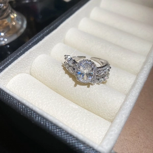 Macro view of silver adjustable oval zircon ring with micro-pave detailing in a jewelry box