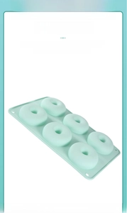 Detail view of the seamless 6-cavity silicone donut mold in light green flexible material