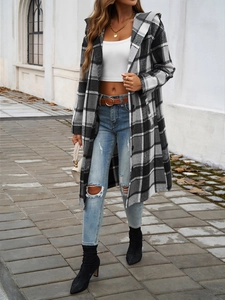 Outdoor street shot of women's casual plaid hooded coat with button closure in grey