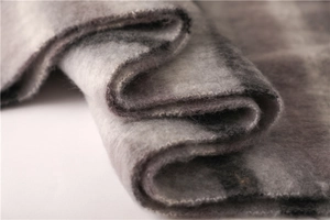 Close-up of soft grey and black plaid faux cashmere fabric texture with thick fibers