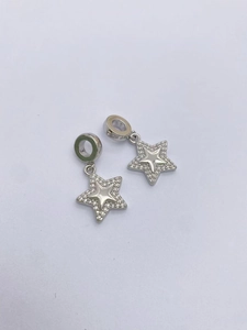 Macro shot of silver starfish charms with micro-pave white zircon and polished center
