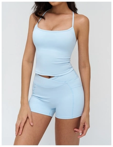 Detailed view of light blue yoga set with high waist crisscross shorts and sports vest