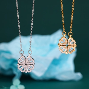 Golden and silver magnetic four-leaf clover heart necklaces with shimmering zircons