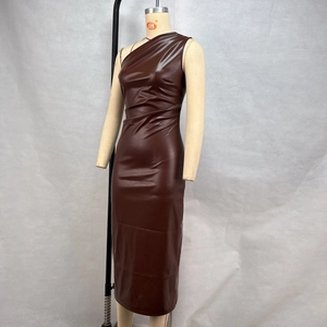 Macro view of the rich brown PU leather texture on a one-shoulder bodycon dress