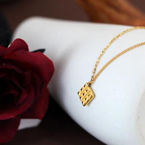 Gold tone square chocolate pendant necklace with AB chain and red rose on white background