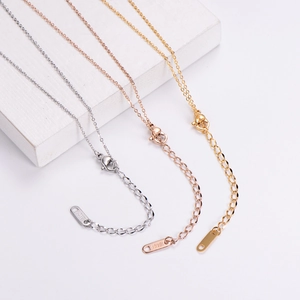 Detail of 18KGP engraving on adjustable lobster clasp of titanium steel necklace