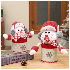Detail of soft snowman candy jars with red hats and knitted scarves for Christmas gifts