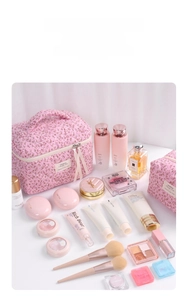 Detailed view of pink cherry blossom quilted makeup bag set with top handle and zippers
