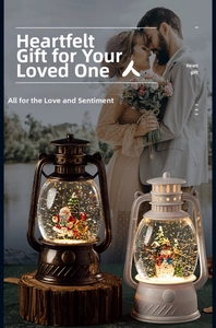 Detail of Christmas lantern snow globe with Santa Claus and festive glitter effect