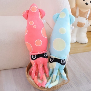 Detail of pink and blue plush squid toys with colorful polka dots in a cozy woven basket