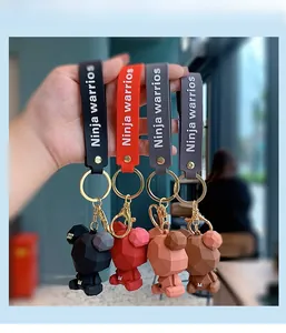 Close-up of colorful geometric 3D bear keychains with stylish branded wrist straps