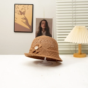 Women's brown crochet sun hat with 3D flower and pearl details on a display stand