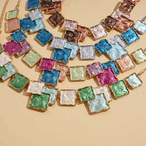 Ethnic style gold necklaces set with colorful geometric squares and enamel inlays