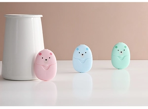 Close-up of portable bear-shaped soap paper cases in pink, blue, and green colors