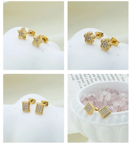 Macro view of four gold-plated star and floral earrings with cubic zirconia pavé