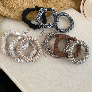 Detailed set of 8 woven elastic hair ties with floral, polka dot, and leopard patterns