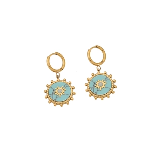 Golden earrings with turquoise sun pendants and small white pearls on white background