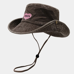 Detail of washed canvas sun hat with pink heart embroidery and adjustable windproof cord