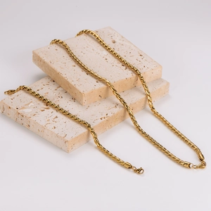 Golden stainless steel dragon bone chain necklace with lobster clasp on stone pedestals