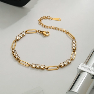 Gold stainless steel tennis bracelet featuring oval links and brilliant round cubic zirconia