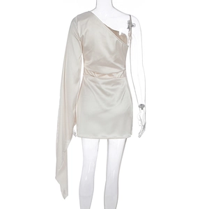 Detail of champagne satin one-shoulder mini dress featuring a long sleeve and silky texture
