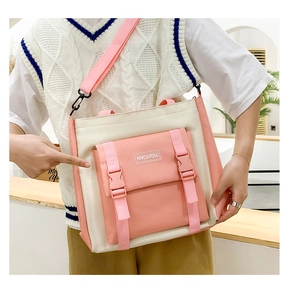 Detail of canvas tote bag with pink flap pocket and adjustable shoulder straps