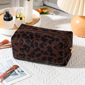 Detailed close-up of a large leopard print makeup bag with a golden zipper puller