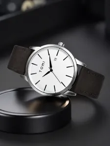 Detailed close-up of minimalistic white dial watch with date display and silver bezel