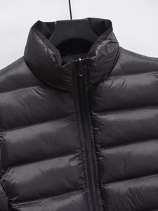 Detail of black quilted puffer vest showing the premium nylon texture and sturdy zipper