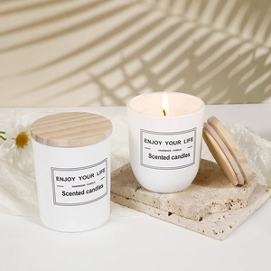 Romantic scented soybean candle in a white glass jar with a natural wooden lid