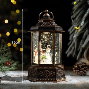 Vintage bronze Christmas snow globe lantern with snowman and warm festive lighting, 25cm height