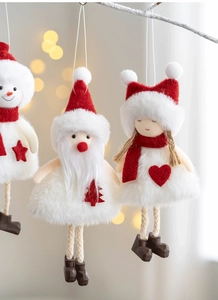 Detail of plush Christmas ornaments featuring Santa, snowman and girl figures with knits