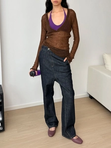 Chic women's sheer brown knit top paired with purple camisole and wide leg blue jeans