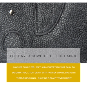 Macro shot of black top layer cowhide with litchi texture and silver rivet detail