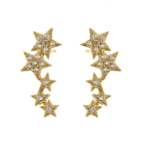 Detailed macro shot of gold brass star earrings with micro-paved cubic zirconia
