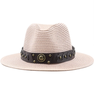 Classic beige woven straw cowboy hat featuring a leather band with horseshoe hardware