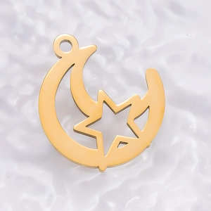Detailed view of gold plated stainless steel star and moon pendant with a polished finish