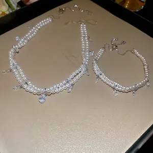 Double-layer pearl jewelry set with zircon teardrop pendants for an elegant women's look
