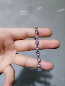 Detail of silver heart bracelet with purple cubic zirconia and vintage beaded edge