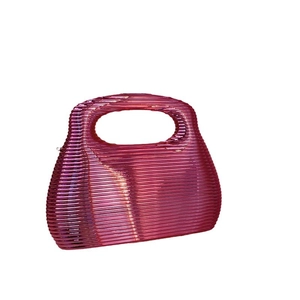 Pink acrylic clutch bag with horizontal stripe texture and hollow oval top handle
