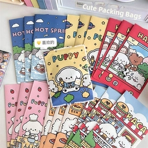 Flat lay of colorful cartoon puppy patterned bubble mailers for safe gift packaging