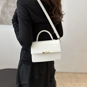 Chic white minimalist rectangular crossbody handbag with metal buckle and slim shoulder strap
