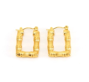 Detail view of gold U-shaped earrings featuring a vintage bamboo textured metal finish